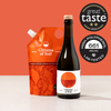 Bottle and pouch of 'Citizens of Soil' olive oil with Great Taste award on an orange background