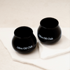Two black olive oil cups with 'Olive Oil Club' text on a white background.