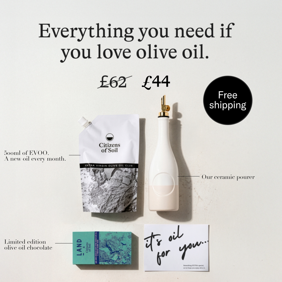 Olive oil product set with bottle, packaging, and card on a light background